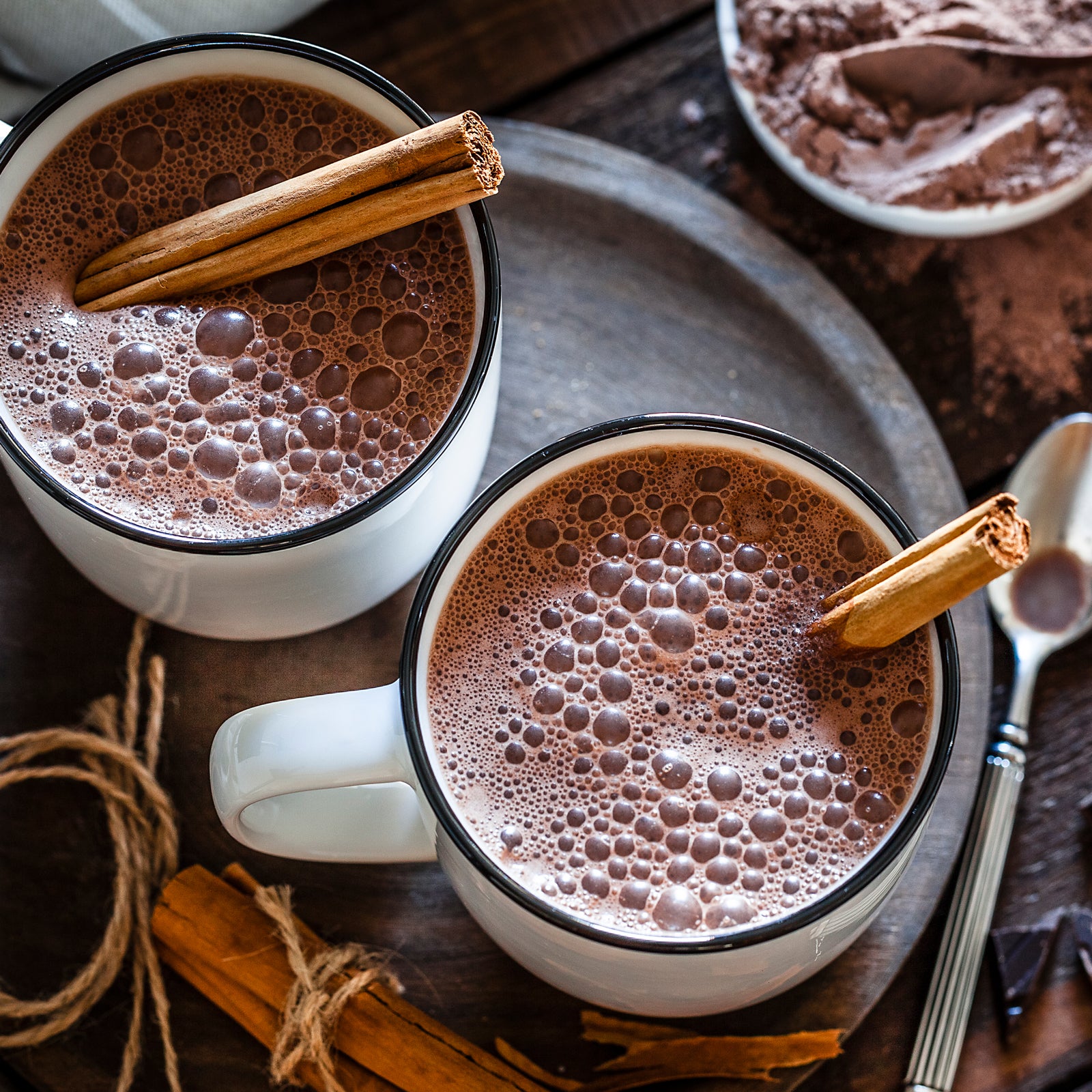 Small thermos with steaming hot drink on snow Stock Photo by