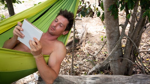 The author writing in his journal on the beach