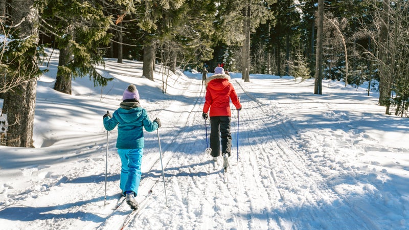 sisters in snowy winter landscape on cross-country-ski
