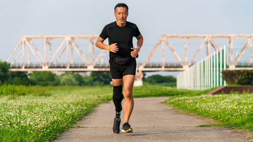 A male runner with a prosthetic leg.