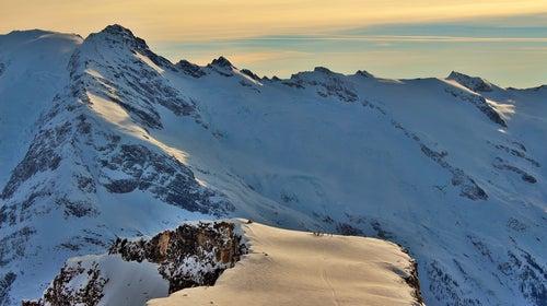 A heli ski group getting dropped off for a day of skiing