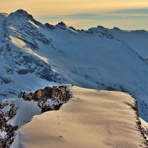 A heli ski group getting dropped off for a day of skiing