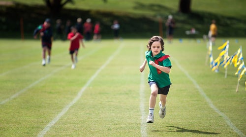 Child With A Determined Expression Winning A Running Race