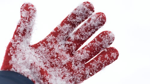 Glove buried in snow after avalanche .