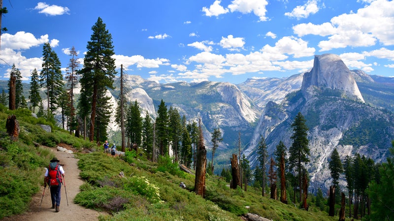 People hikers hiking in Yosemite National Park on sunny day