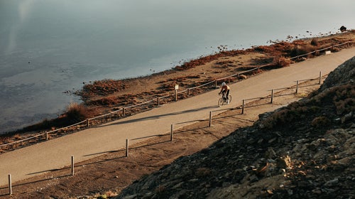 Cyclist Riding Next To The Ocean