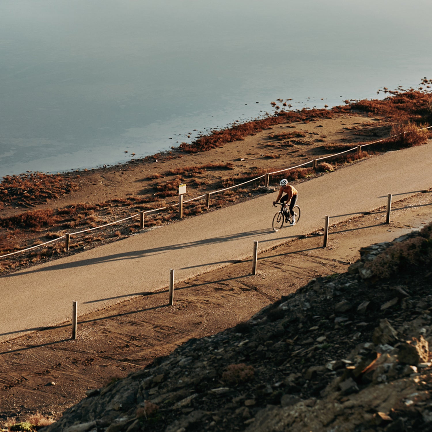 Cyclist Riding Next To The Ocean