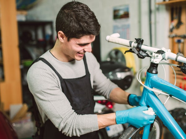 Mechanic repairing a bicycle in his workshop