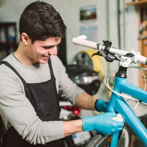 Mechanic repairing a bicycle in his workshop