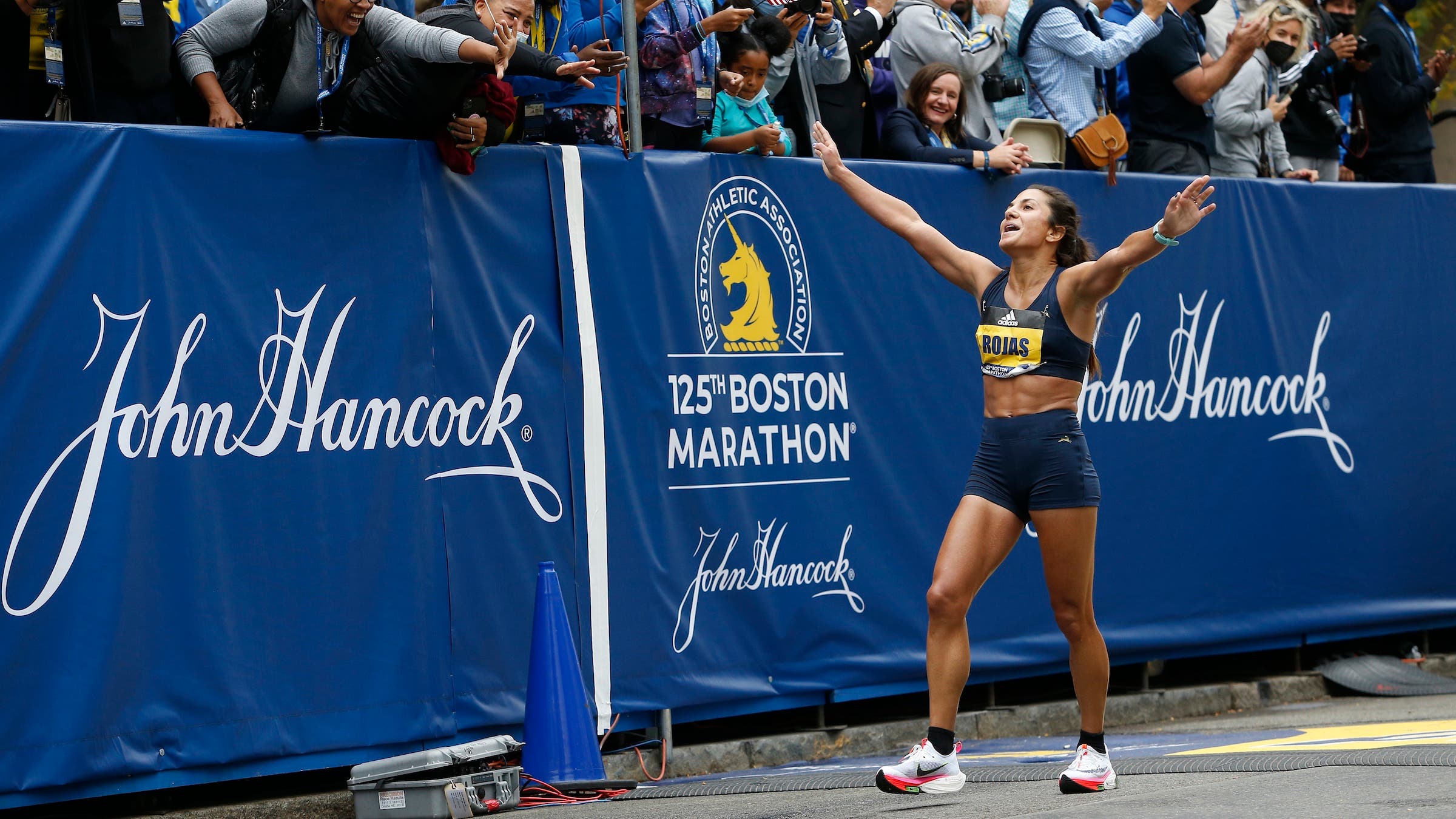 Rojas outstretches her arms to the crowd after crossing the Finish Line of the 125th Boston Marathon in Boston, MA on Oct. 11, 2021. (Photo by Jessica Rinaldi/The )