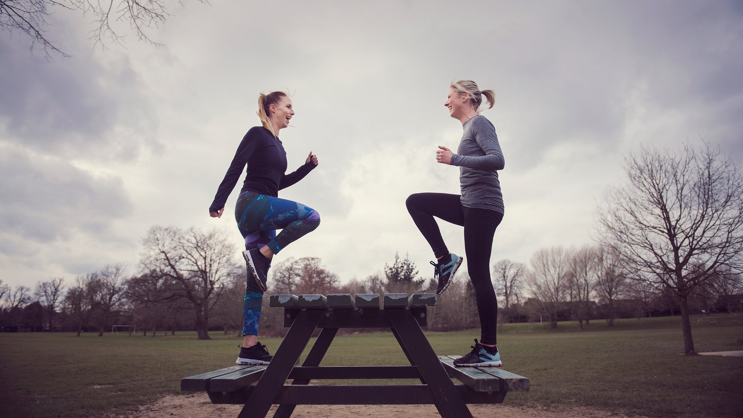 women doing step-ups on picnic bench