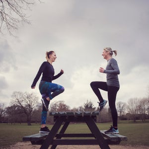 side view of women doing step ups on picnic bench