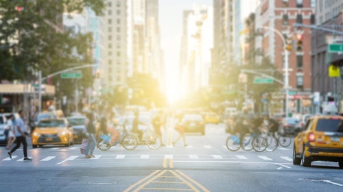 People crossing the busy intersection in Manhattan in New York City
