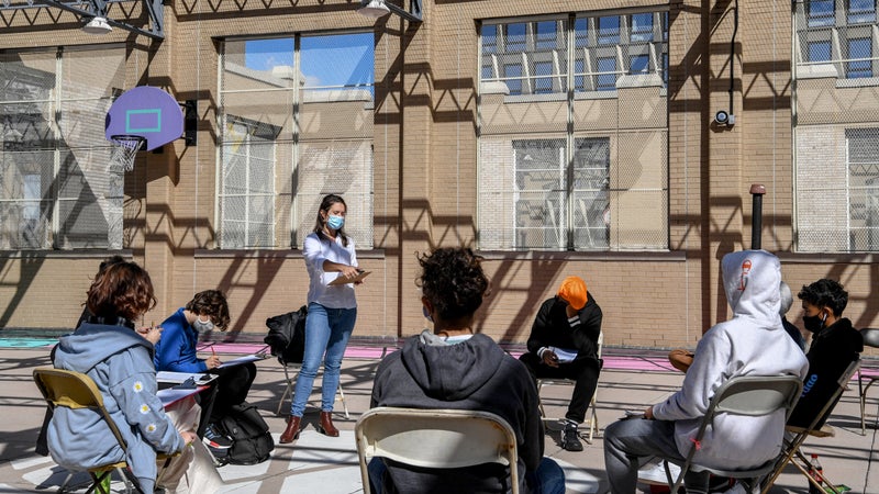 Jane Collins teaches an interdisciplinary class of ninth and tenth graders on the rooftop of Essex Street Academy in Manhattan, Oct. 8, 2020. (Desiree Rios/The New York Times)