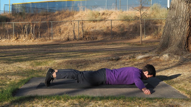 man on stomach with arms out in T