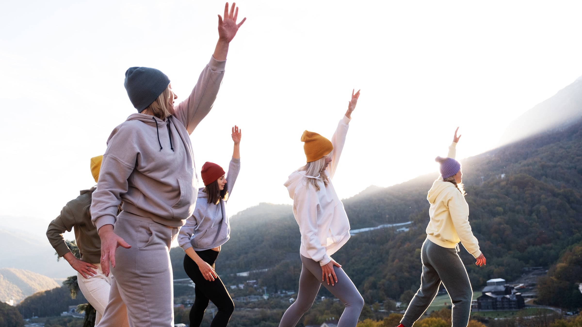 Group Of Women Exercising Near Mountain