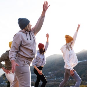 Group Of Women Exercising Near Mountain