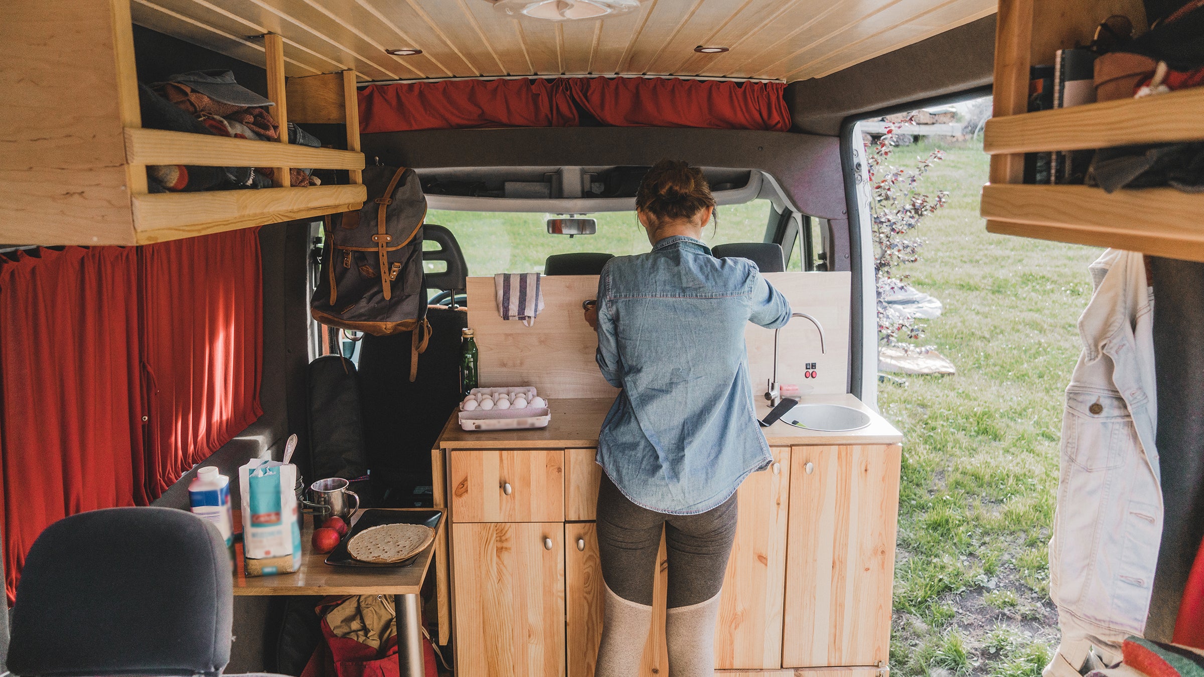 Woman cooking pancakes  in camper van