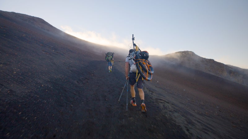 Antin and Chambers hiking with their bikes in Maui