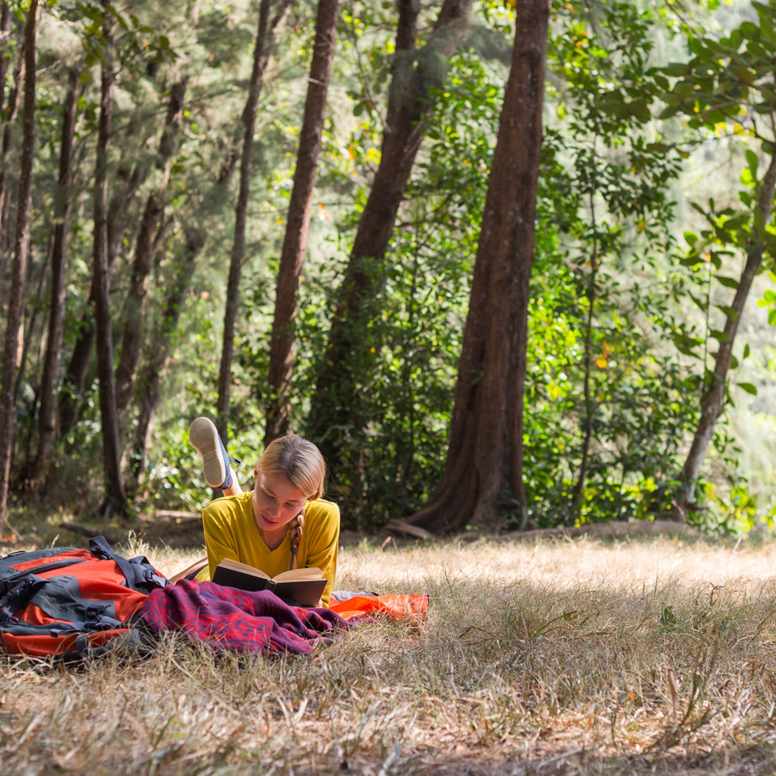 Woman Reading Book Next To The Tent