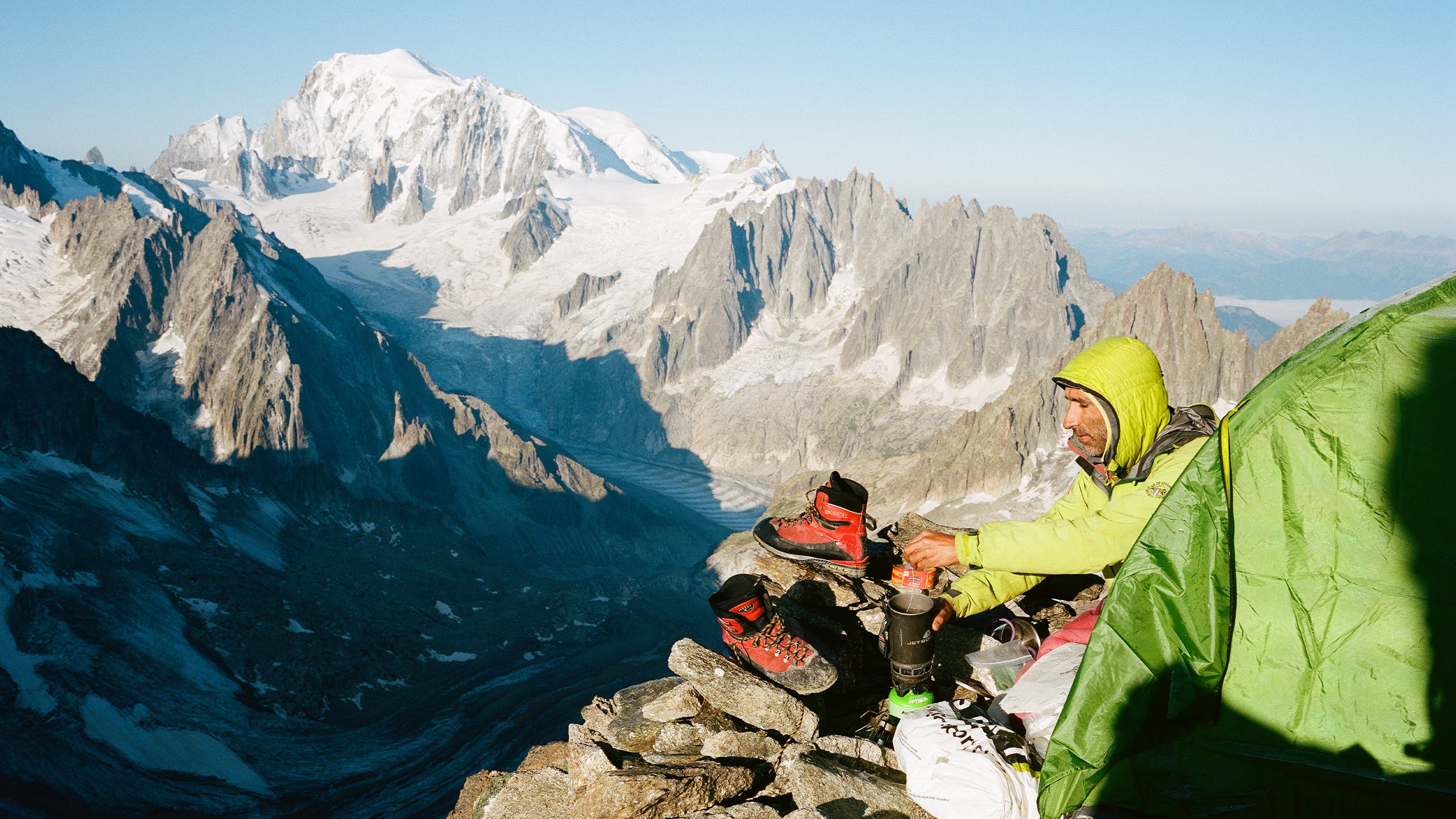 Elías brewing a morning cup of tea at the Col des Cristaux bivouac.