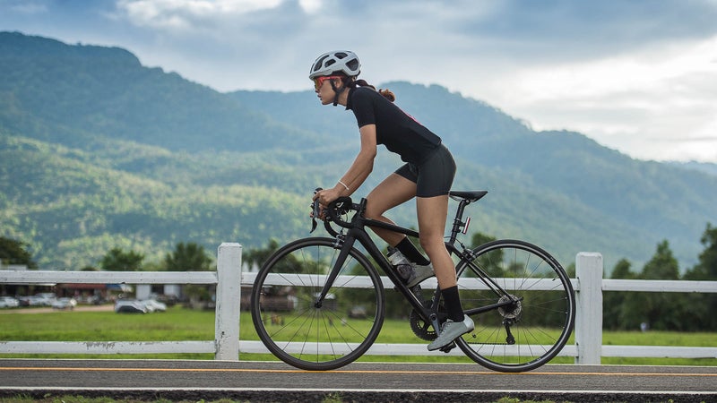 Asian female cyclist cycling on track