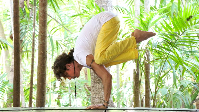 Transgender yogini practicing on wooden platform
