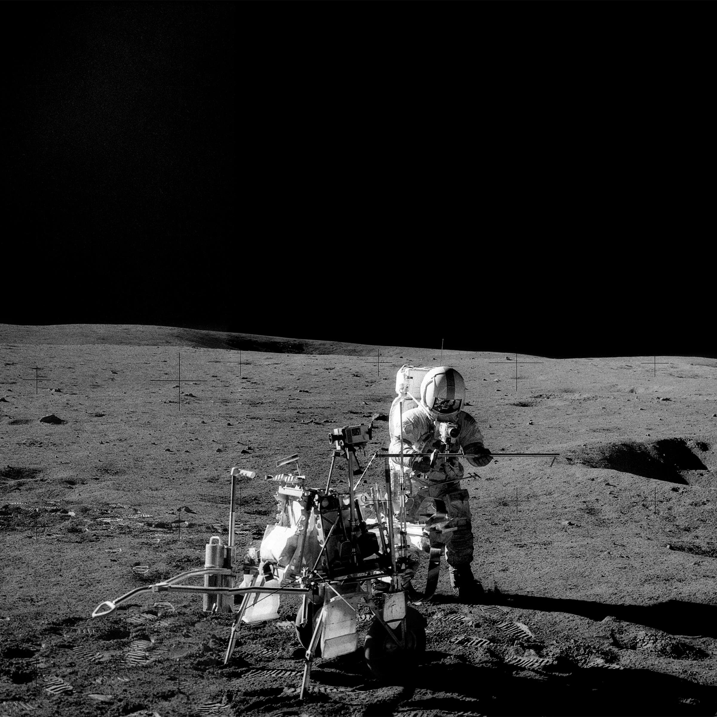 Astronaut Alan B. Shepard Jr. works during Apollo 14’s lunar visit in February 1971. Beside him is the Modular Equipment Transporter, a handcart for tools and rock samples.