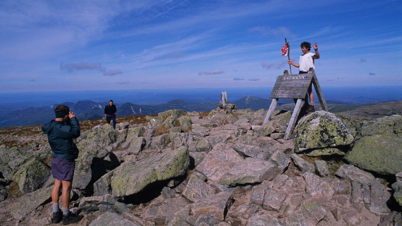 Hikers celebrating at the northern terminus of the Appalachian Trail atop Katahdin in Maine