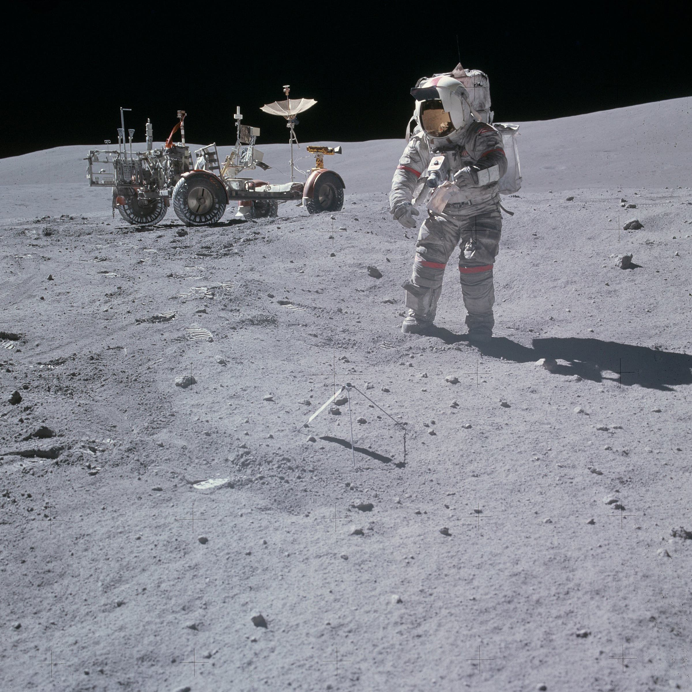 Young holds a sample bag as he prepares to gather rocks during his third extravehicular activity with astronaut Charlie Duke, in April 1972.