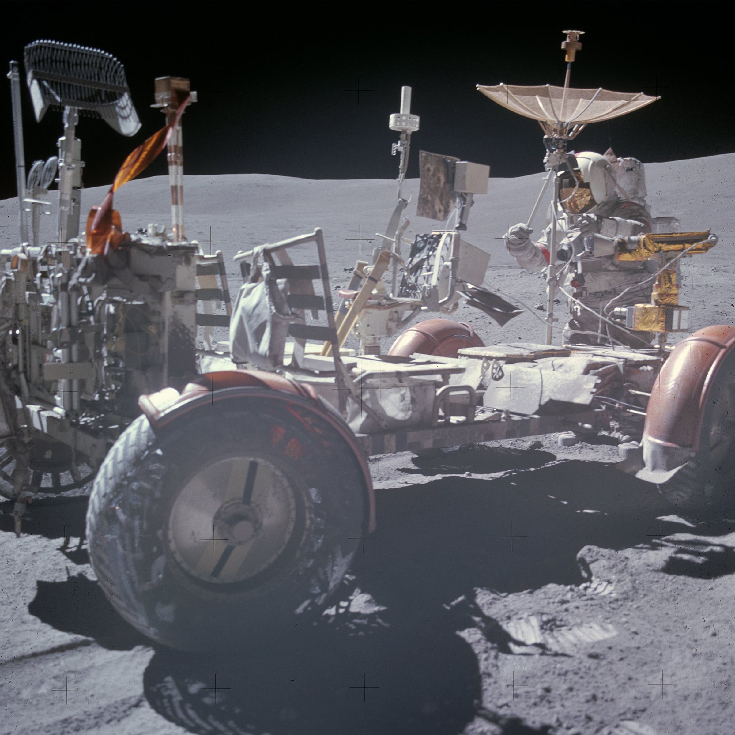 Apollo 16 commander John Young uses an eyepiece to aim the second rover’s high-gain antenna, which carried live TV signals to Earth.