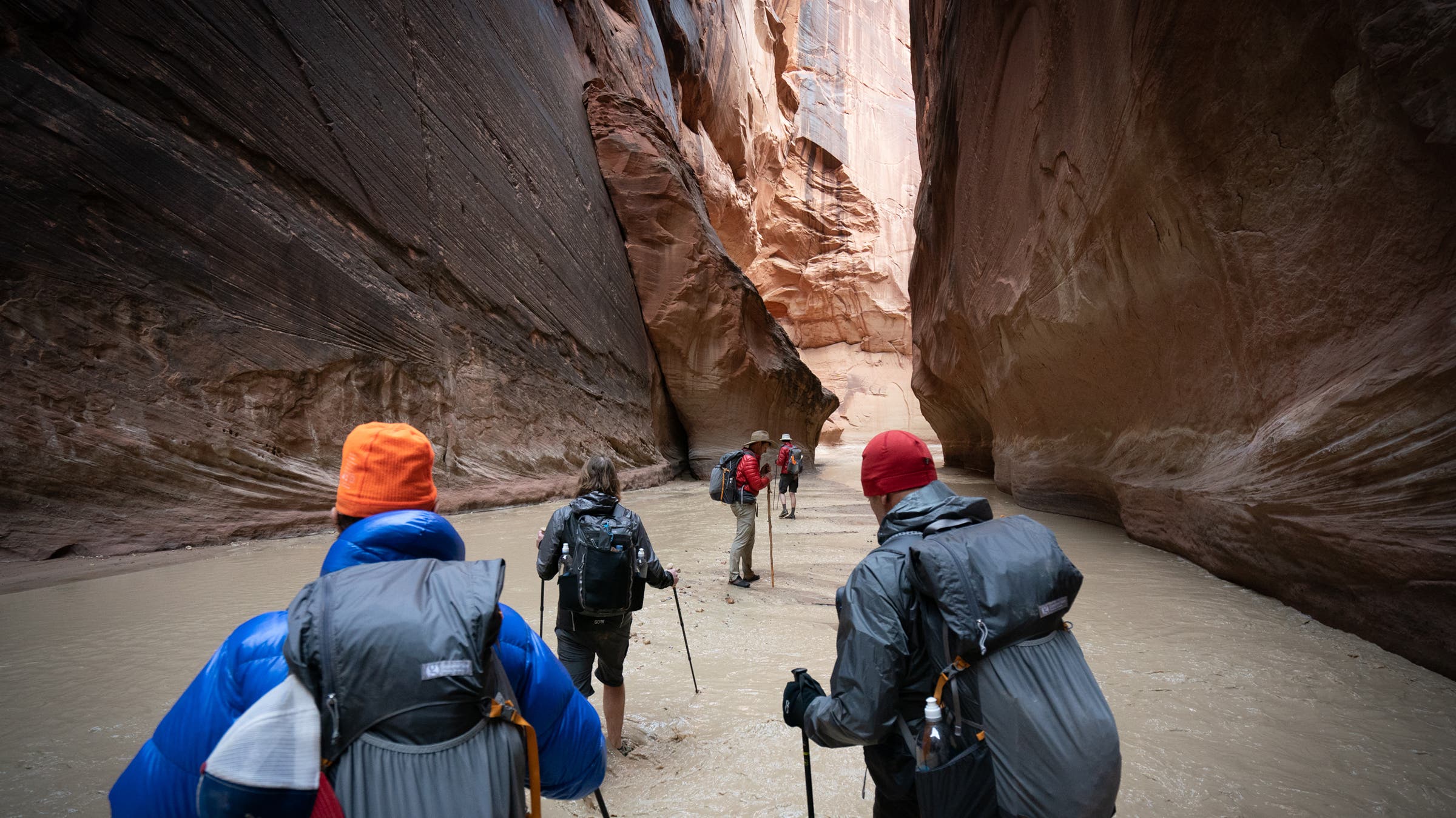 The group makes their way up the canyon on Day one through freezing water.