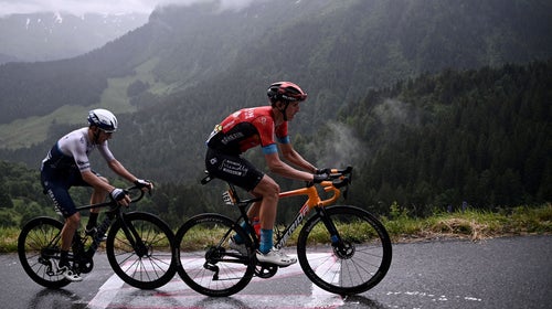 Michael Woods (left) climbs during the 8th stage of the 2021 Tour de France.
