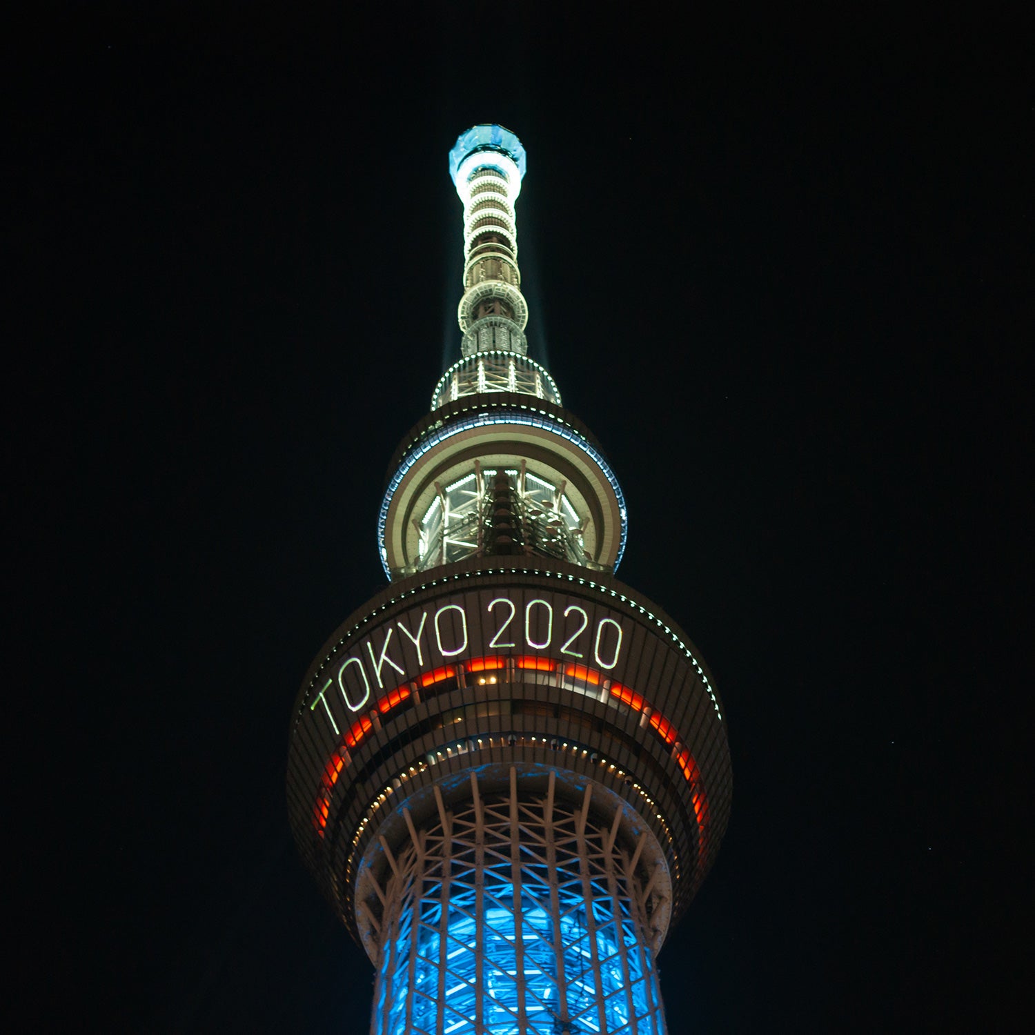 The skytree tower is illuminated at night announcing the olympics of Tokyo 2020.