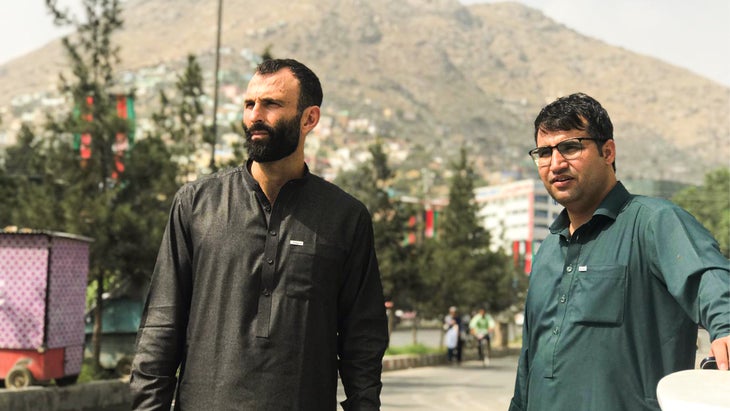 Jason Motlagh and Aziz Tassal taking a break on a Kabul street
