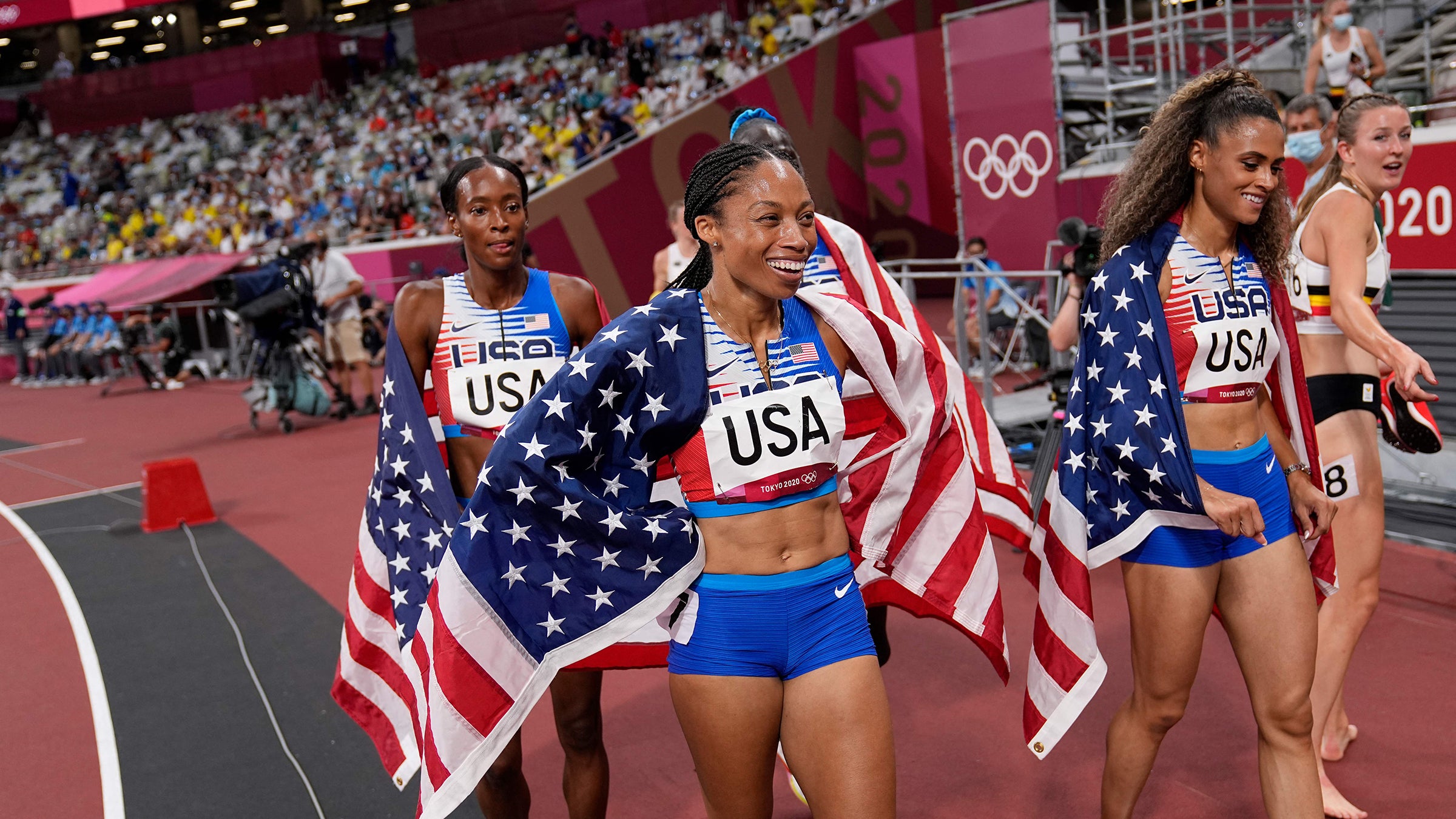 Allyson Felix, Athing Mu, Dalilah Muhammad and Sydney Mclaughlin celebrate after winning the women's 4x400 relay final.