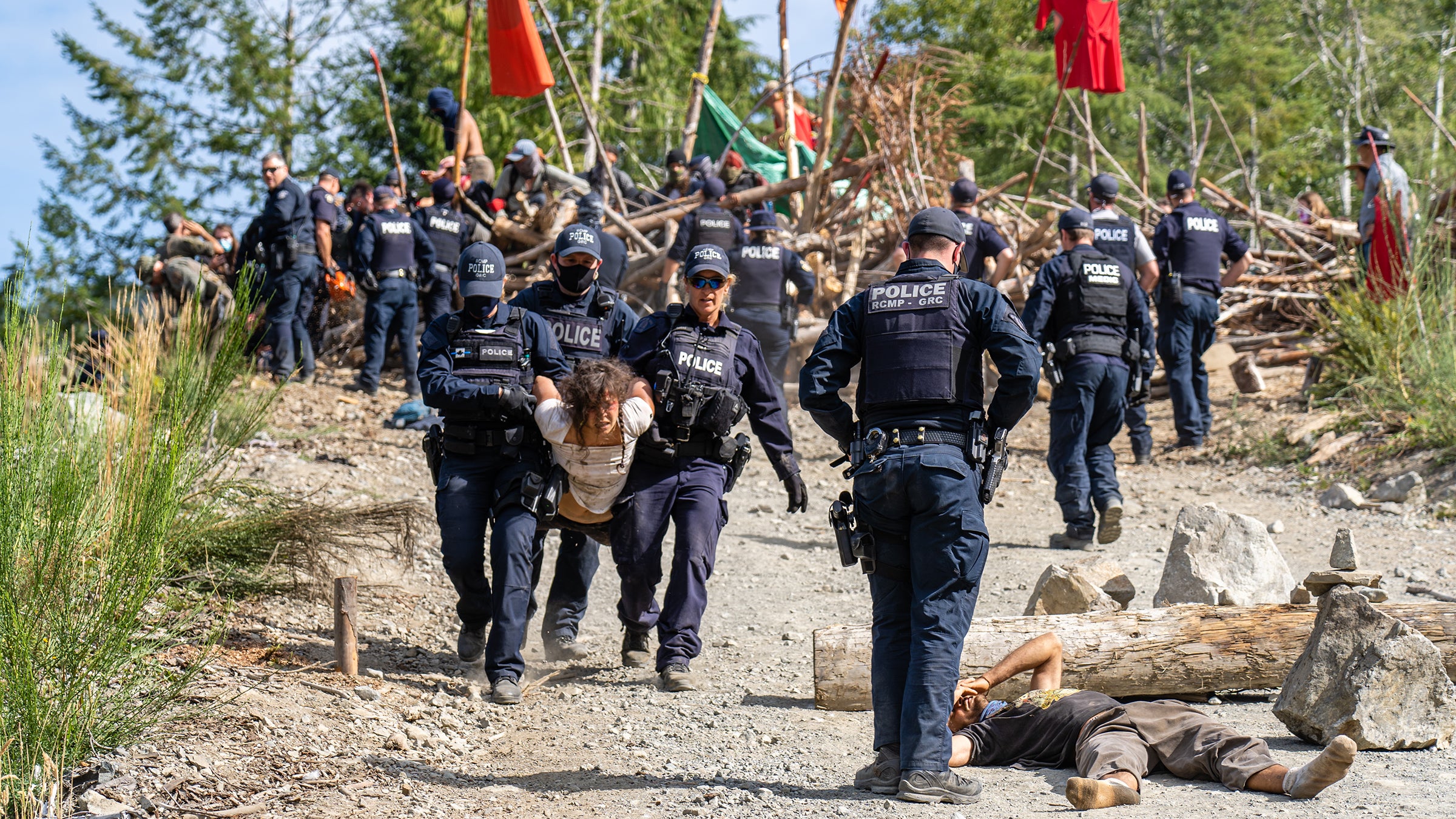 An activist is carried away from a blockade by law enforcement.