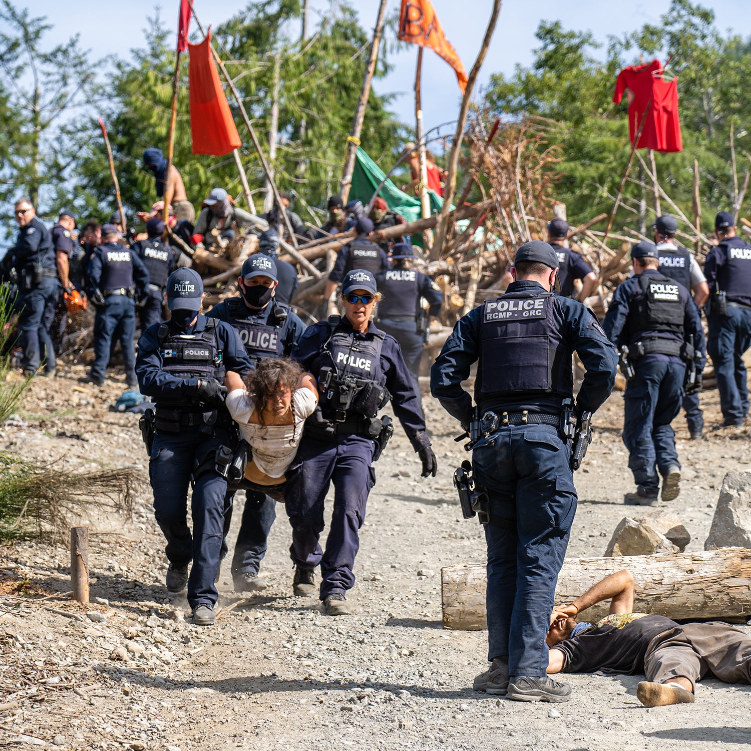 An activist is carried away from a blockade by law enforcement.