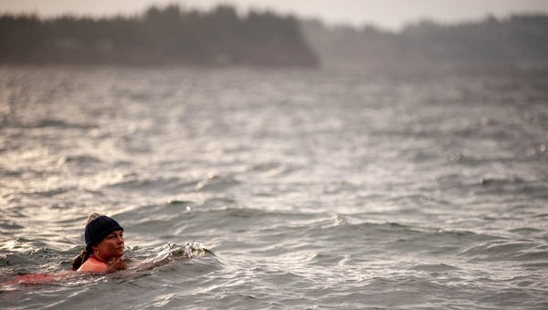woman swimming with hat in cold water