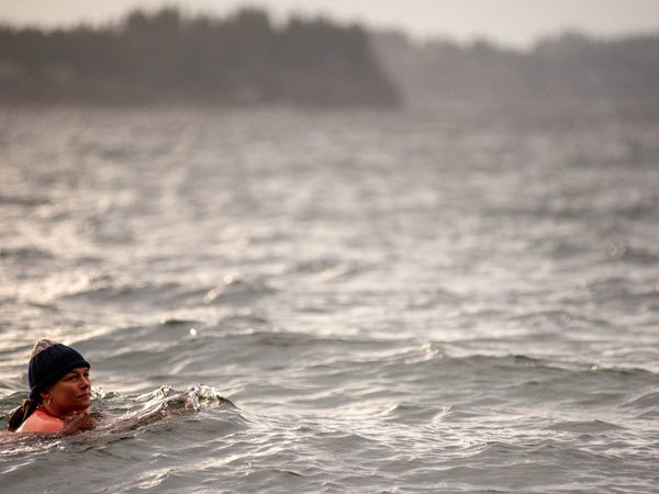 woman swimming with hat in cold water