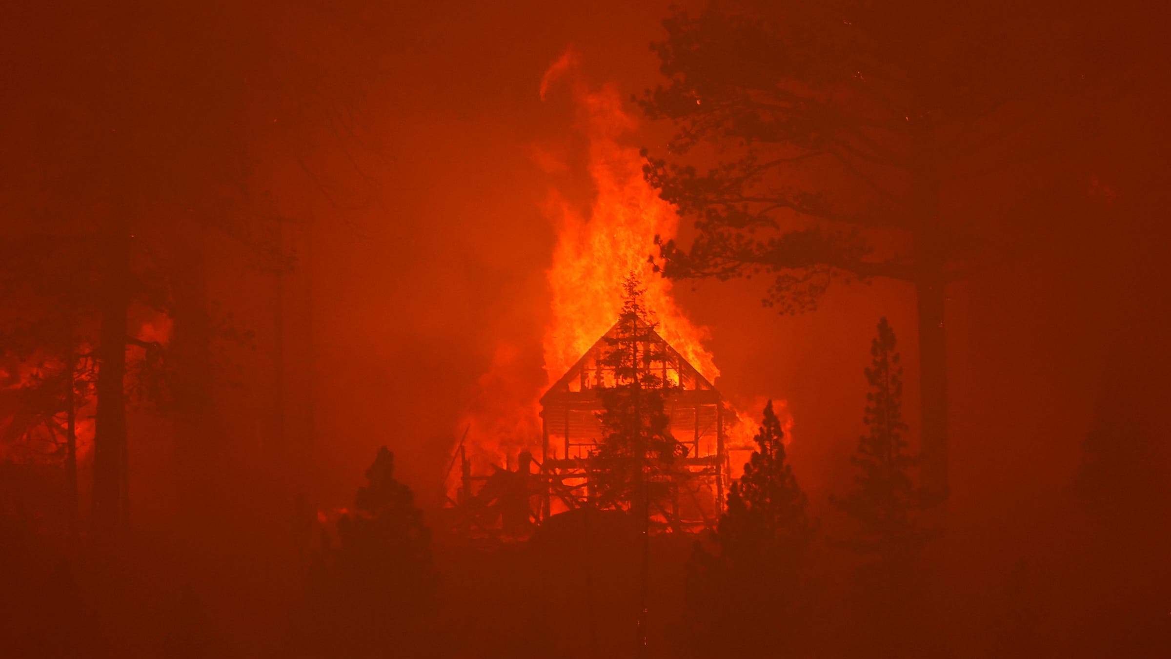 The Caldor Fire burns homes along a ridge on August 30, 2021 near South Lake Tahoe, California.