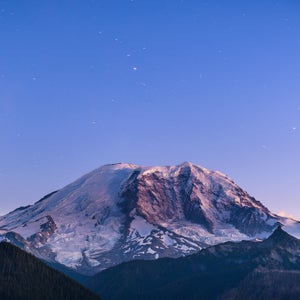 Scenic view of snowcapped mountain against blue sky at dusk