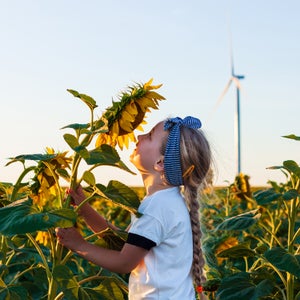 Girl smelling sunflower