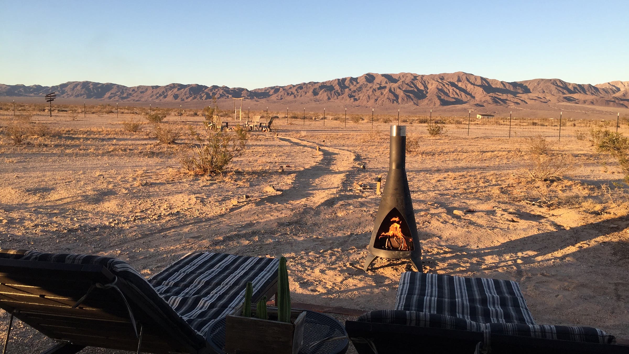 lawn chairs looking out into mountains and desert landscape