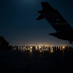 A U.S. Air Force aircrew, assigned to the 816th Expeditionary Airlift Squadron, prepare to load qualified evacuees aboard a U.S. Air Force C-17 Globemaster III aircraft in support of Afghanistan evacuation at Hamid Karzai International Airport, Afghanistan, Aug. 21, 2021. The Department of Defense is committed to supporting the U.S. State Department in the departure of U.S. and allied civilian personnel from Afghanistan, and to evacuate Afghan allies safely. (U.S. Air Force photo by Senior Airman Taylor Crul)