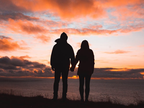 Couple silhouette by ocean