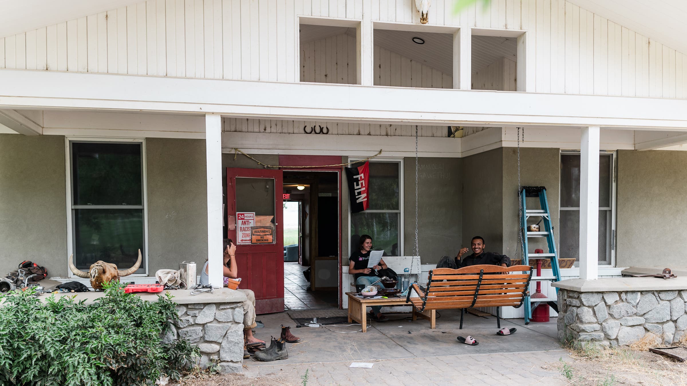 Lucia Pizarro and Amin Stambuli chatting on the front porch of the dorm