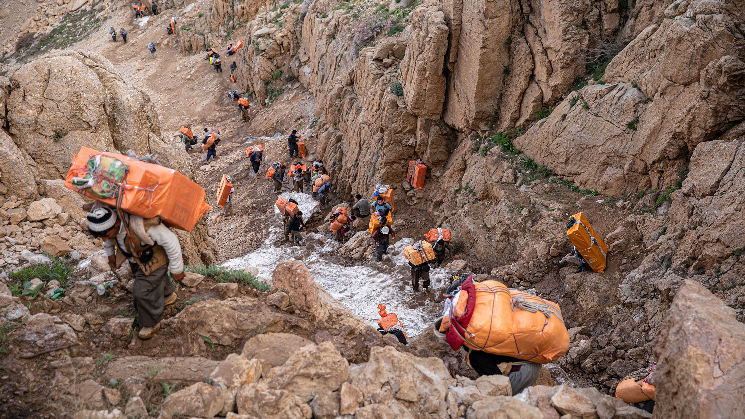 Along the most popular kolbar routes, the lines of men and women carrying loads can reach a mile long.