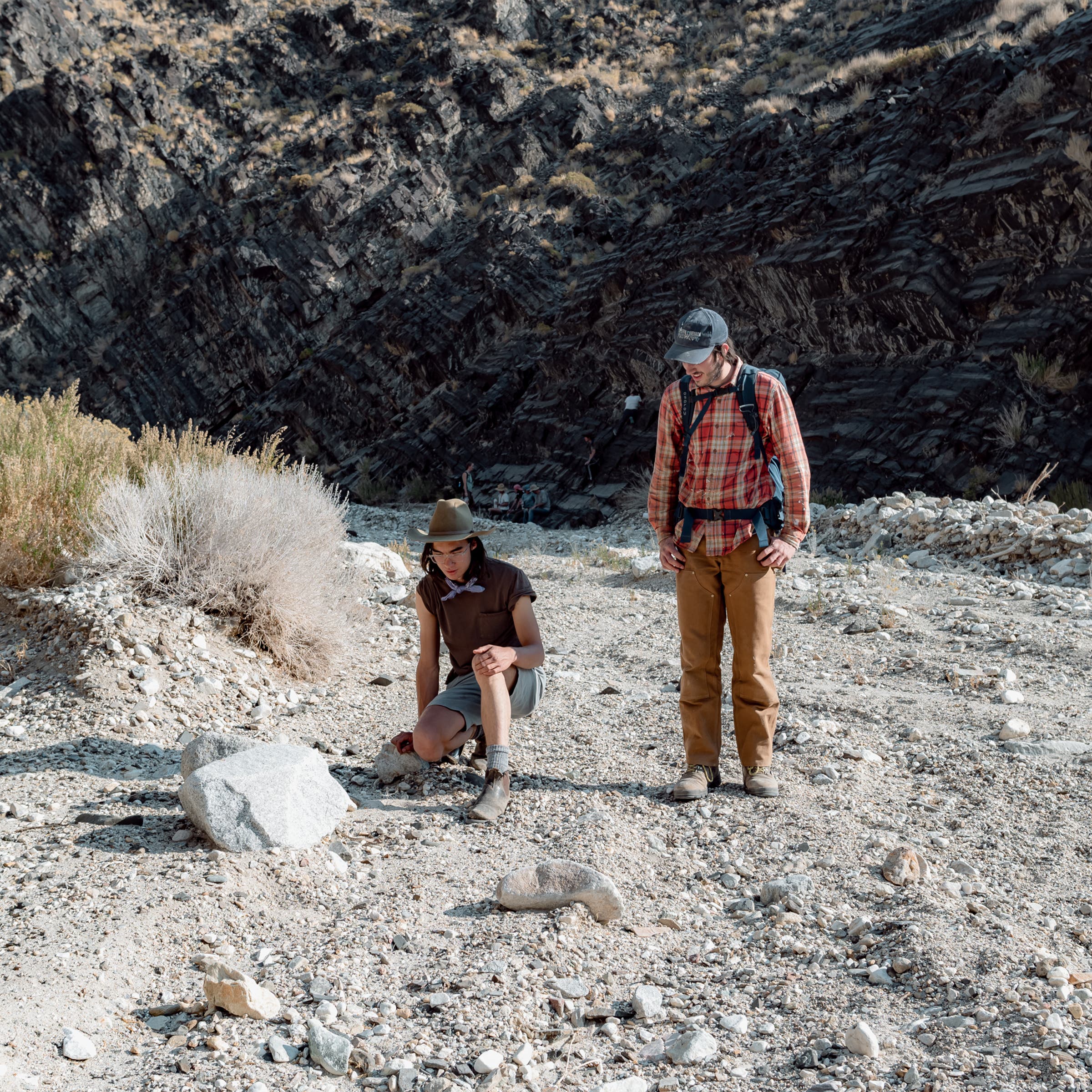 Milo Vela and Julien Ricou inspecting a tarantula