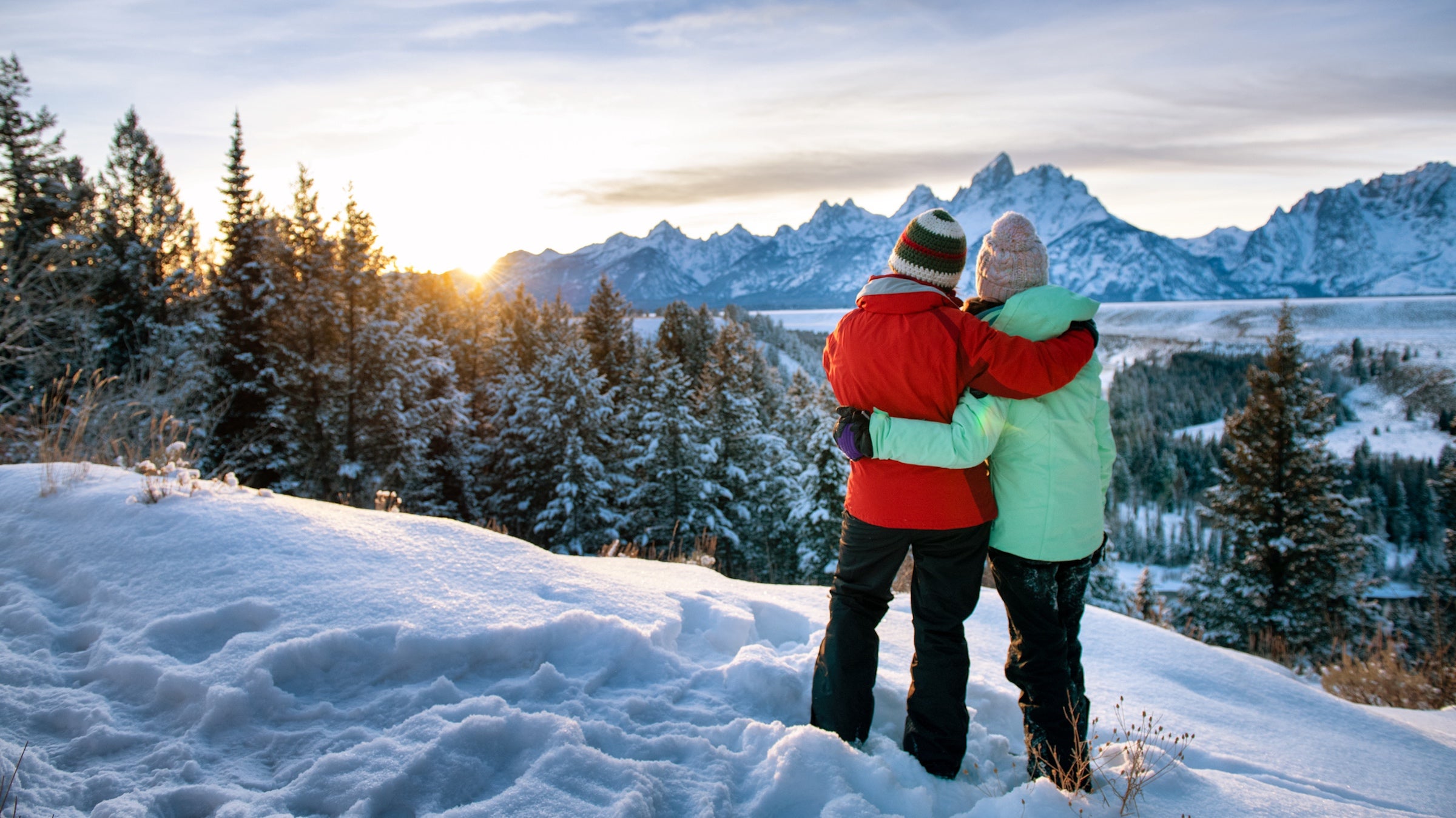 mom and daughter on snowy mountain